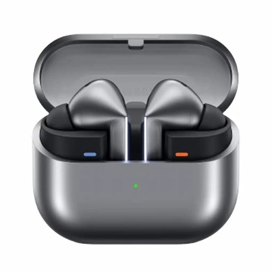 True wireless earbuds in an open charging case, shown on a plain white background. The earbuds are dark gray with black inner sections, and the case is metallic dark gray with a small green indicator light.